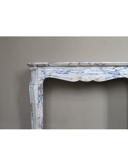 Antique Baroque mantel carved in rare Calacatta Gold marble with veining in shades of violet, gold, and white.