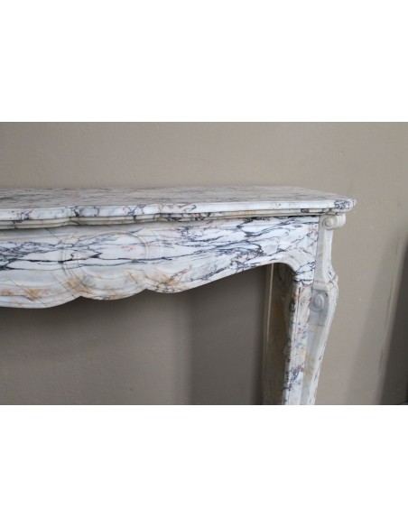 Antique Baroque mantel carved in rare Calacatta Gold marble with veining in shades of violet, gold, and white.