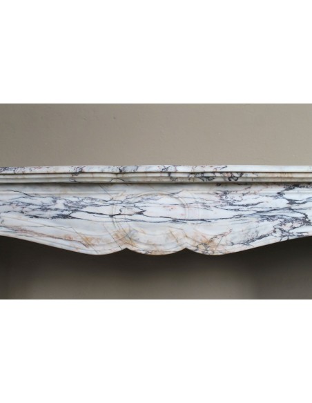 Antique Baroque mantel carved in rare Calacatta Gold marble with veining in shades of violet, gold, and white.