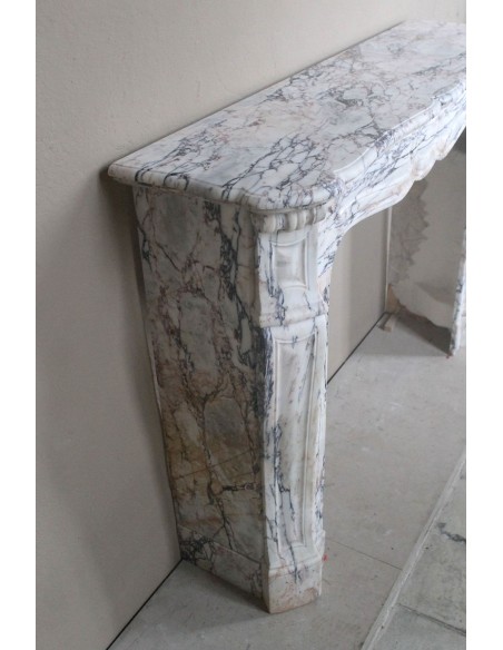 Antique Baroque mantel carved in rare Calacatta Gold marble with veining in shades of violet, gold, and white.