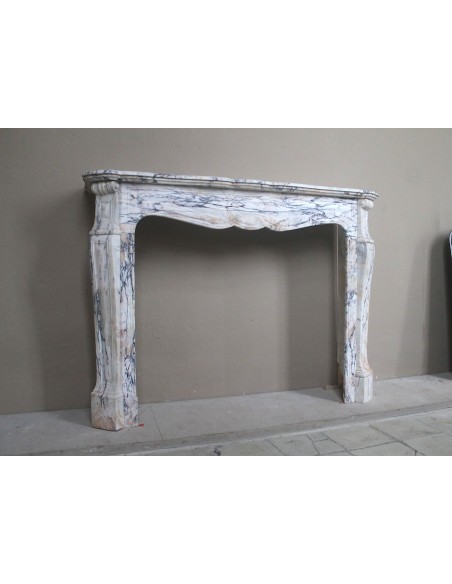 Antique Baroque mantel carved in rare Calacatta Gold marble with veining in shades of violet, gold, and white.