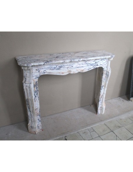 Antique Baroque mantel carved in rare Calacatta Gold marble with veining in shades of violet, gold, and white.