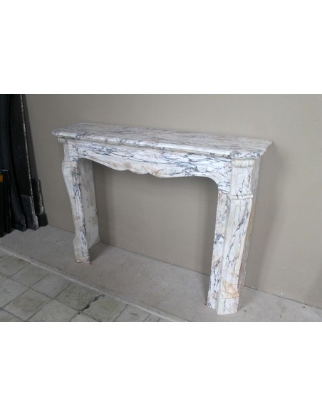 Antique Baroque mantel carved in rare Calacatta Gold marble with veining in shades of violet, gold, and white.