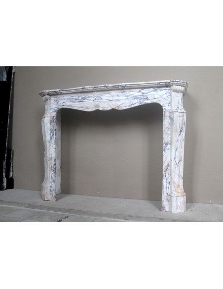 Antique Baroque mantel carved in rare Calacatta Gold marble with veining in shades of violet, gold, and white.