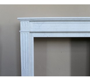 Louis XVI “Cannelure” fireplace mantel carved in “Pure” Bianco Carrara marble. A sober, elegant, and linear antique fireplace. 2