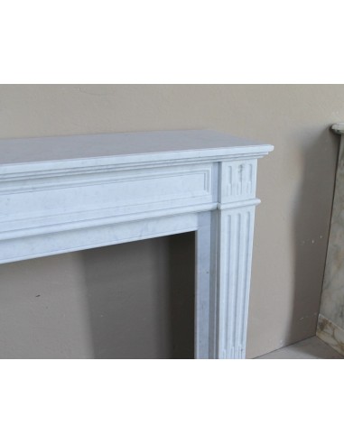 Louis XVI “Cannelure” fireplace mantel carved in “Pure” Bianco Carrara marble. A sober, elegant, and linear antique fireplace.