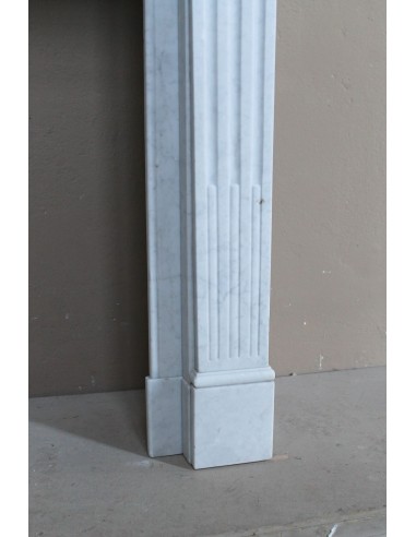Louis XVI “Cannelure” fireplace mantel carved in “Pure” Bianco Carrara marble. A sober, elegant, and linear antique fireplace.