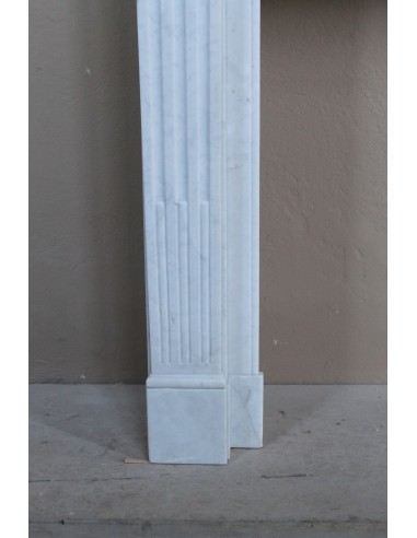 Louis XVI “Cannelure” fireplace mantel carved in “Pure” Bianco Carrara marble. A sober, elegant, and linear antique fireplace.