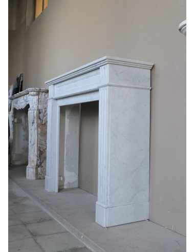 Louis XVI “Cannelure” fireplace mantel carved in “Pure” Bianco Carrara marble. A sober, elegant, and linear antique fireplace.
