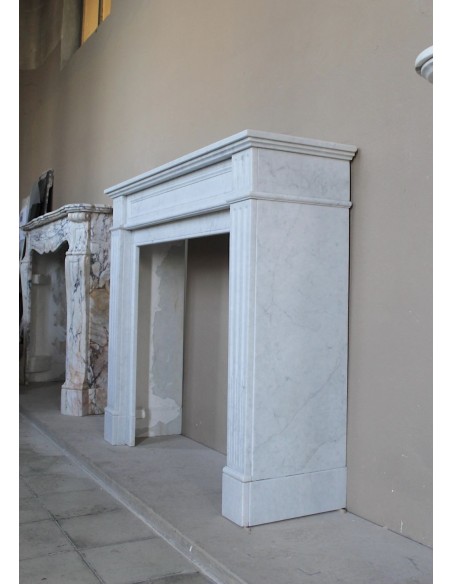 Louis XVI “Cannelure” fireplace mantel carved in “Pure” Bianco Carrara marble. A sober, elegant, and linear antique fireplace.