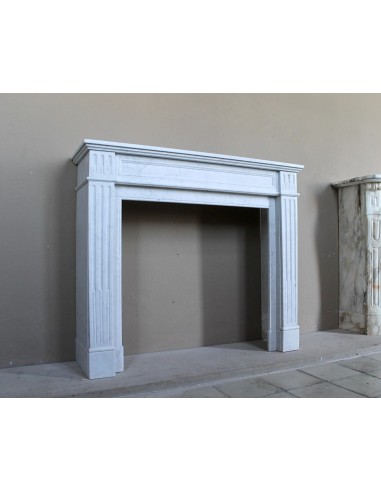 Louis XVI “Cannelure” fireplace mantel carved in “Pure” Bianco Carrara marble. A sober, elegant, and linear antique fireplace.