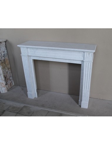 Louis XVI “Cannelure” fireplace mantel carved in “Pure” Bianco Carrara marble. A sober, elegant, and linear antique fireplace.