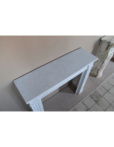 Louis XVI “Cannelure” fireplace mantel carved in “Pure” Bianco Carrara marble. A sober, elegant, and linear antique fireplace.