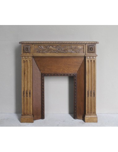 Charming small-scale Louis XVI “Olive Branch” fireplace mantel carved in oak wood, complete with insert and closure.