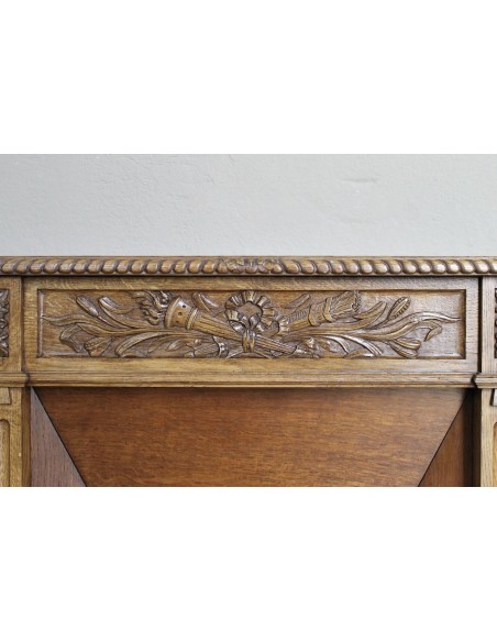 Charming small-scale Louis XVI “Olive Branch” fireplace mantel carved in oak wood, complete with insert and closure.