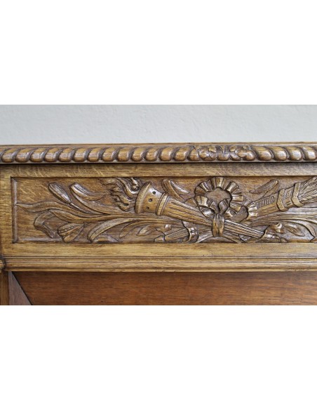 Charming small-scale Louis XVI “Olive Branch” fireplace mantel carved in oak wood, complete with insert and closure.