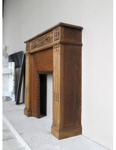 Charming small-scale Louis XVI “Olive Branch” fireplace mantel carved in oak wood, complete with insert and closure.