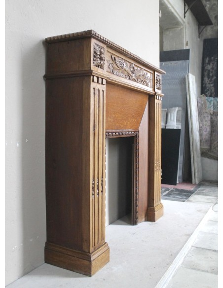 Charming small-scale Louis XVI “Olive Branch” fireplace mantel carved in oak wood, complete with insert and closure.