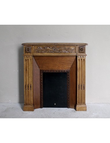 Charming small-scale Louis XVI “Olive Branch” fireplace mantel carved in oak wood, complete with insert and closure.