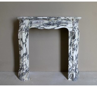 Louis XV “Pompadour” fireplace mantel in Breccia Medicea marble, featuring strong purple, green, gold and white veining.