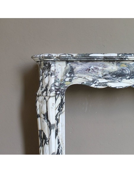 Louis XV “Pompadour” fireplace mantel in Breccia Medicea marble, featuring strong purple, green, gold and white veining.