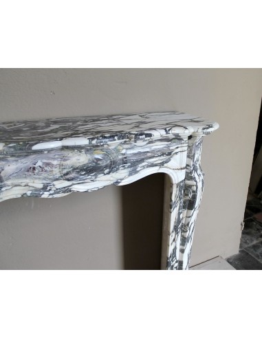 Louis XV “Pompadour” fireplace mantel in Breccia Medicea marble, featuring strong purple, green, gold and white veining.