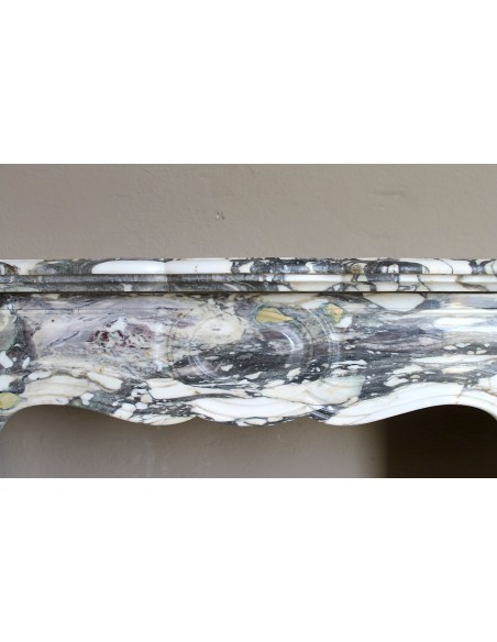 Louis XV “Pompadour” fireplace mantel in Breccia Medicea marble, featuring strong purple, green, gold and white veining.