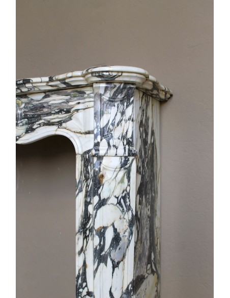 Louis XV “Pompadour” fireplace mantel in Breccia Medicea marble, featuring strong purple, green, gold and white veining.