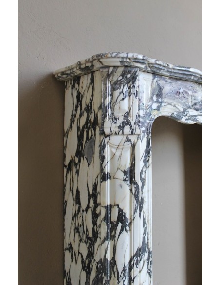 Louis XV “Pompadour” fireplace mantel in Breccia Medicea marble, featuring strong purple, green, gold and white veining.