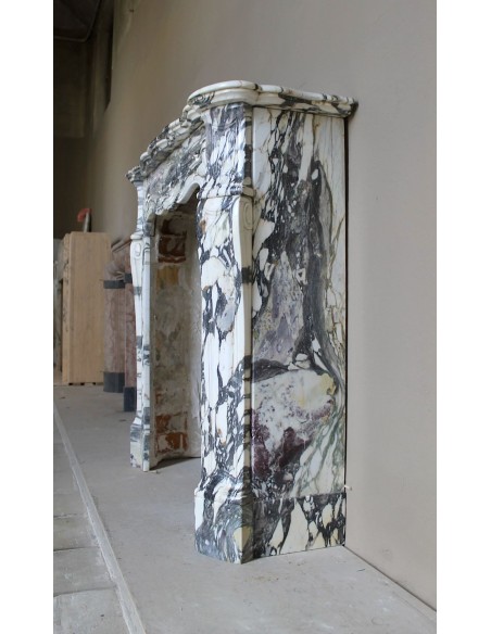 Louis XV “Pompadour” fireplace mantel in Breccia Medicea marble, featuring strong purple, green, gold and white veining.