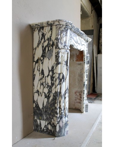 Louis XV “Pompadour” fireplace mantel in Breccia Medicea marble, featuring strong purple, green, gold and white veining.