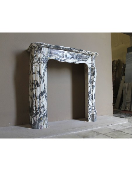 Louis XV “Pompadour” fireplace mantel in Breccia Medicea marble, featuring strong purple, green, gold and white veining.