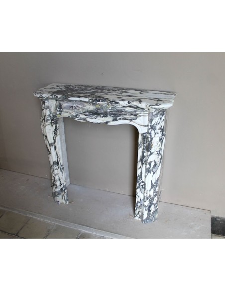 Louis XV “Pompadour” fireplace mantel in Breccia Medicea marble, featuring strong purple, green, gold and white veining.