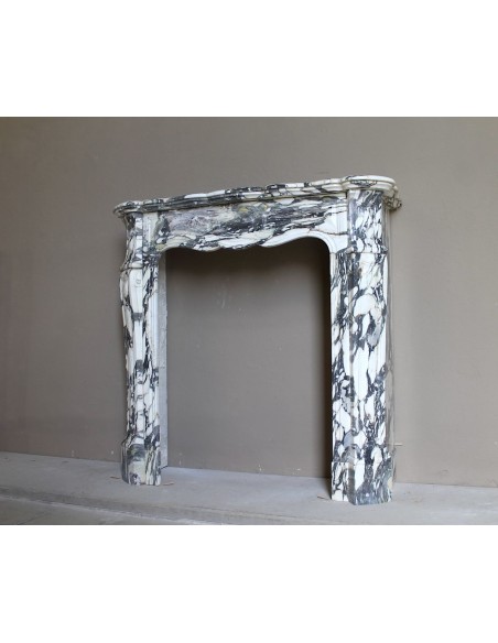 Louis XV “Pompadour” fireplace mantel in Breccia Medicea marble, featuring strong purple, green, gold and white veining.