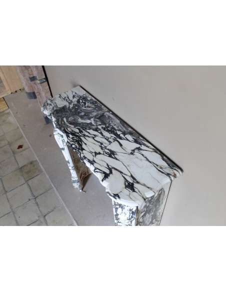 Louis XV “Pompadour” fireplace mantel in Breccia Medicea marble, featuring strong purple, green, gold and white veining.