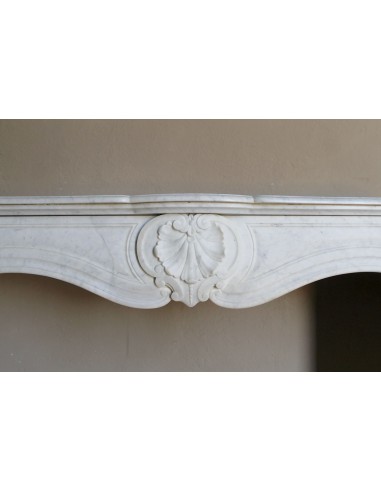 Louis XV “Coquille” fireplace mantel in white marble with sculpted shell decorations. A genuine antique marble fire surround.