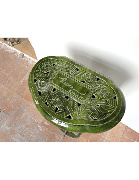Antique Deville “Hiver” stove in green enameled cast iron, with floral decorative elements, from the Art Deco period.