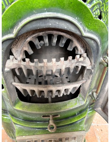 Antique Deville “Hiver” stove in green enameled cast iron, with floral decorative elements, from the Art Deco period.