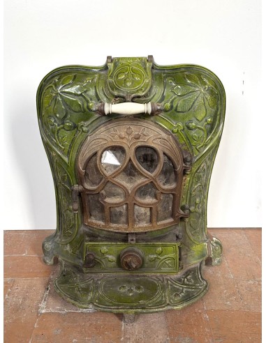 Antique “Lux” stove in green enameled cast iron, with floral and foliate decorations. A genuine and rare fireplace stove.