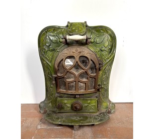 Antique “Lux” stove in green enameled cast iron, with floral and foliate decorations. A genuine and rare fireplace stove.