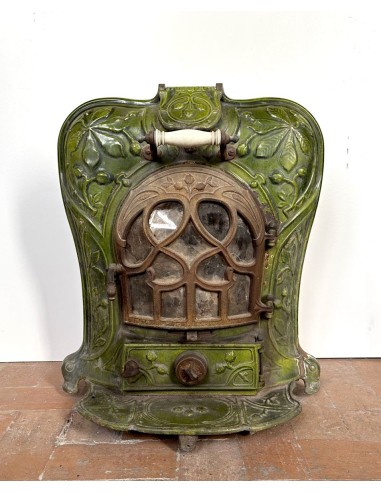 Antique “Lux” stove in green enameled cast iron, with floral and foliate decorations. A genuine and rare fireplace stove.