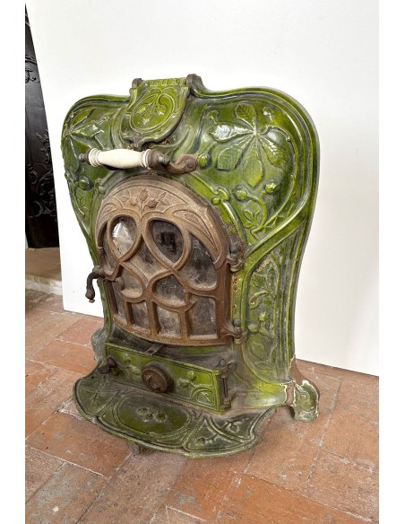 Antique “Lux” stove in green enameled cast iron, with floral and foliate decorations. A genuine and rare fireplace stove.