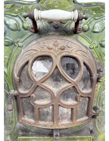 Antique “Lux” stove in green enameled cast iron, with floral and foliate decorations. A genuine and rare fireplace stove.
