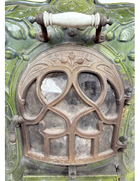 Antique “Lux” stove in green enameled cast iron, with floral and foliate decorations. A genuine and rare fireplace stove.