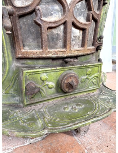 Antique “Lux” stove in green enameled cast iron, with floral and foliate decorations. A genuine and rare fireplace stove.