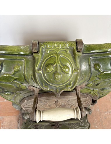 Antique “Lux” stove in green enameled cast iron, with floral and foliate decorations. A genuine and rare fireplace stove.