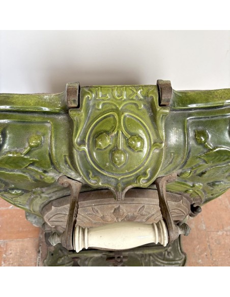 Antique “Lux” stove in green enameled cast iron, with floral and foliate decorations. A genuine and rare fireplace stove.