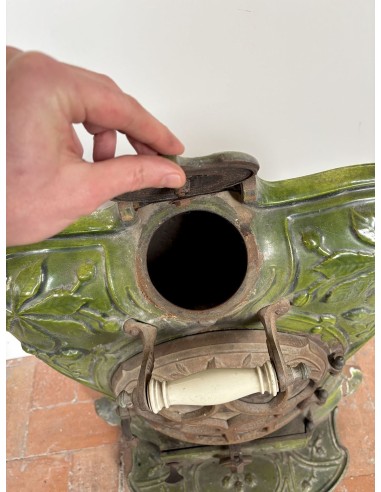 Antique “Lux” stove in green enameled cast iron, with floral and foliate decorations. A genuine and rare fireplace stove.