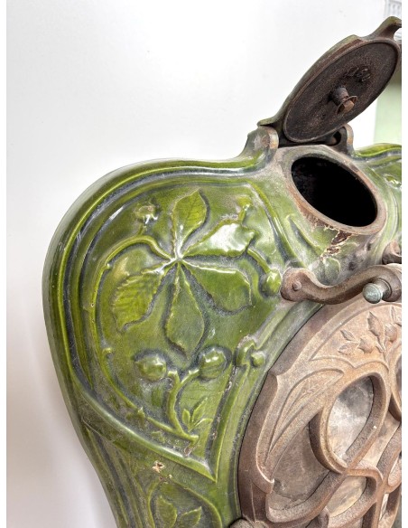 Antique “Lux” stove in green enameled cast iron, with floral and foliate decorations. A genuine and rare fireplace stove.