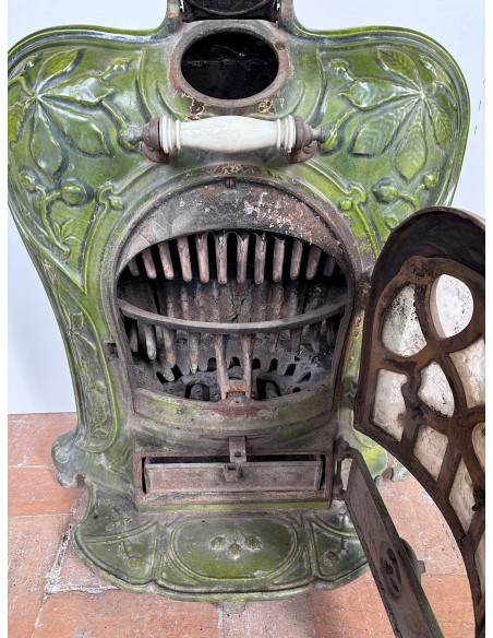Antique “Lux” stove in green enameled cast iron, with floral and foliate decorations. A genuine and rare fireplace stove.